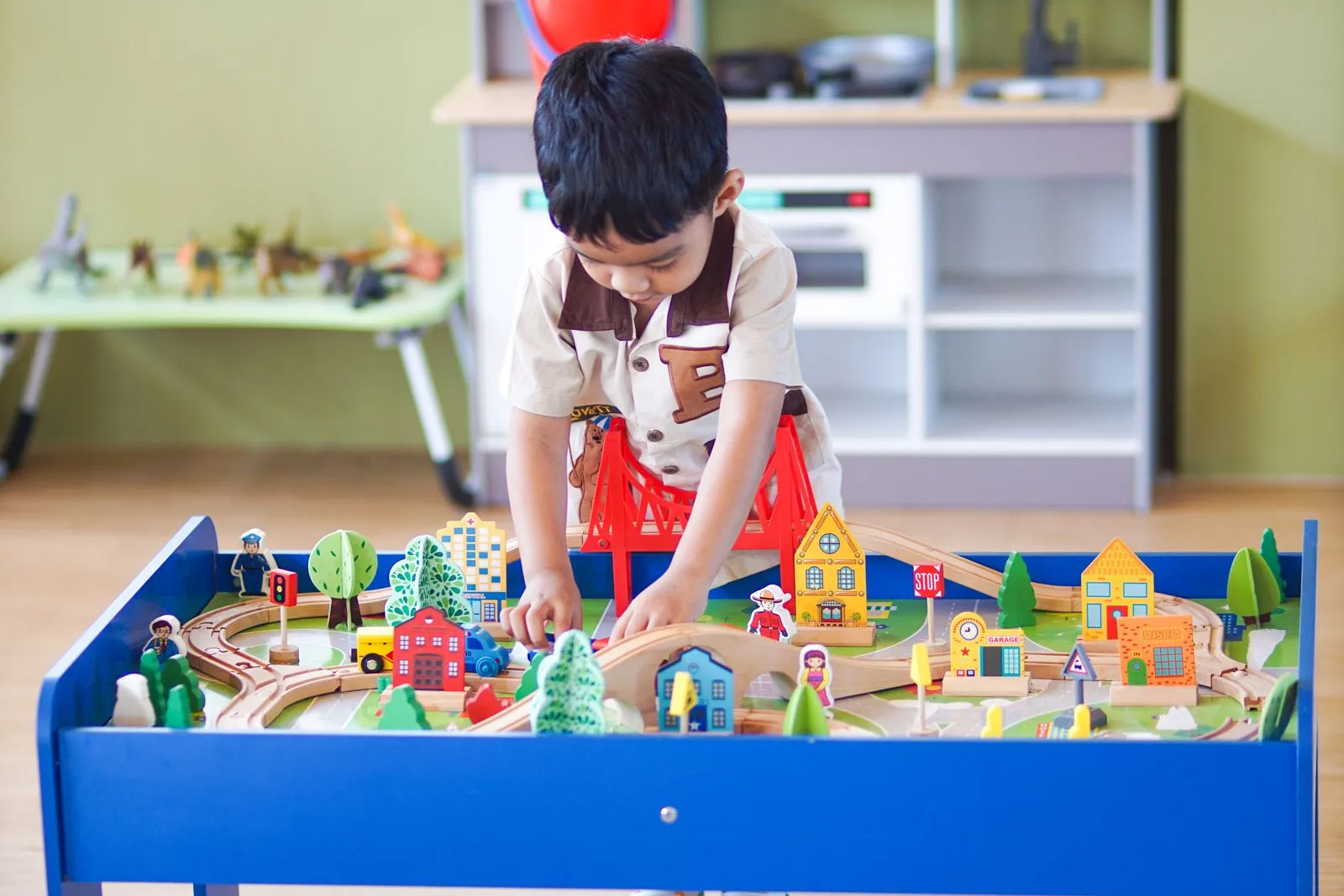 Young boy playing with a colorful wooden toy set, enhancing creativity and learning indoors.
